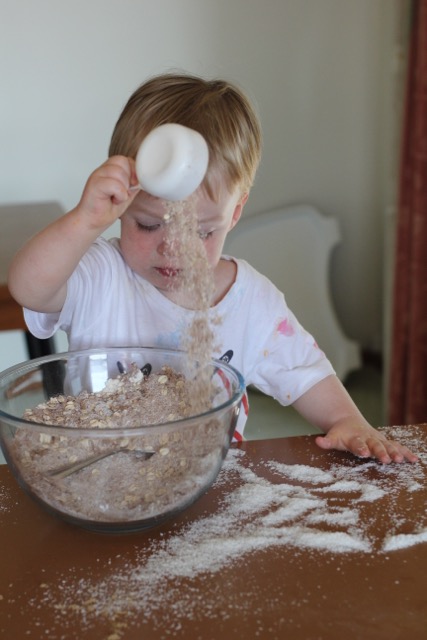 child pouring coconut into a bowl